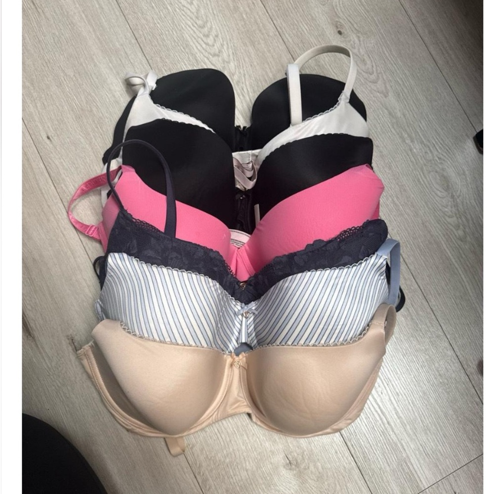 Set of Four Bras in Black, Pink, Striped, and Nude